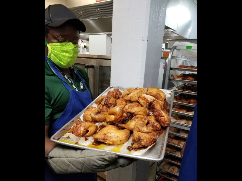Chef Amana shows a tray of chicken he cooked at St Vinnys Bistro.  This BBQ chicken was part of a tasty meal delivered to the homeless of San Antonio at an off-site location.